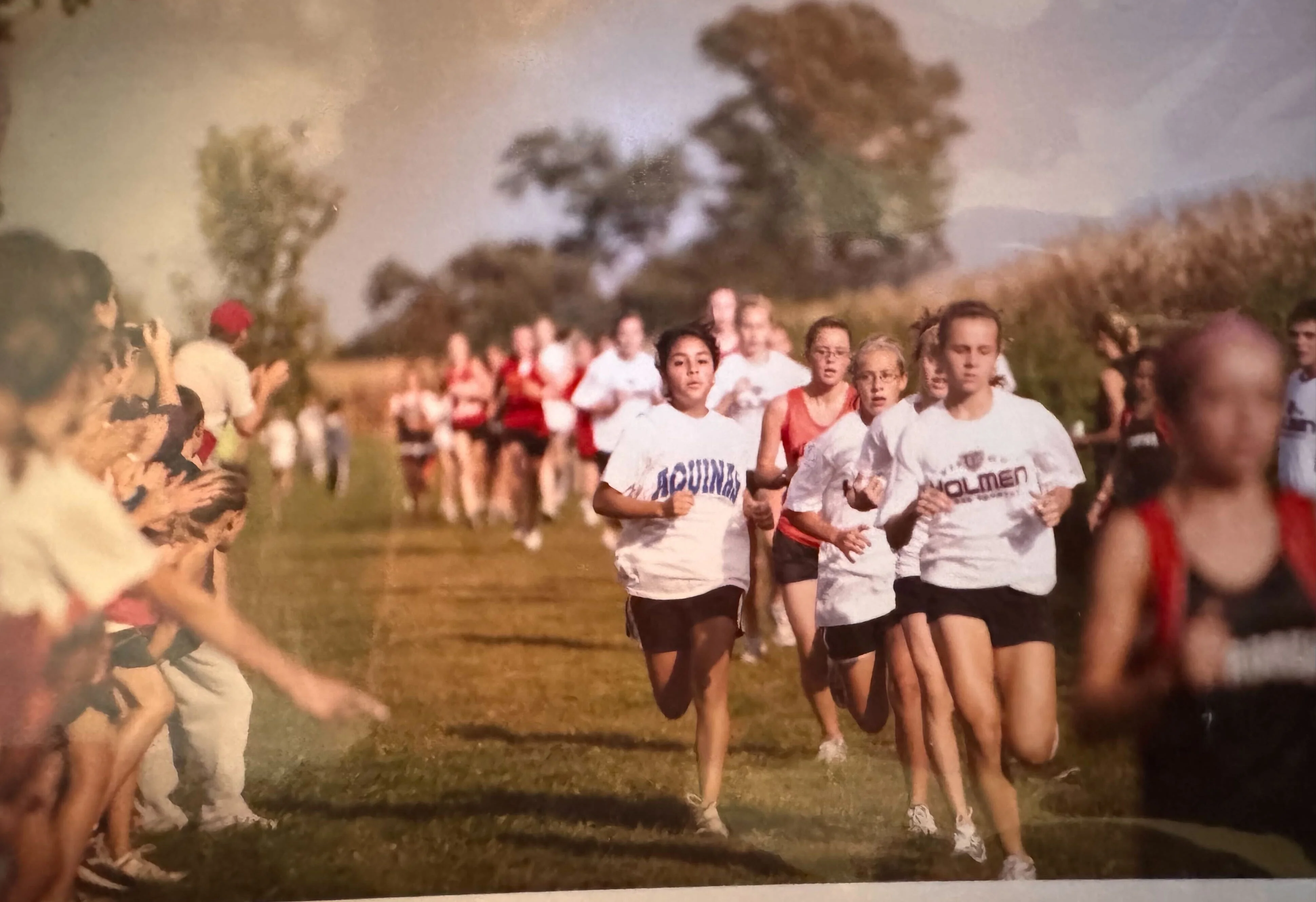 group of girls running cross county race