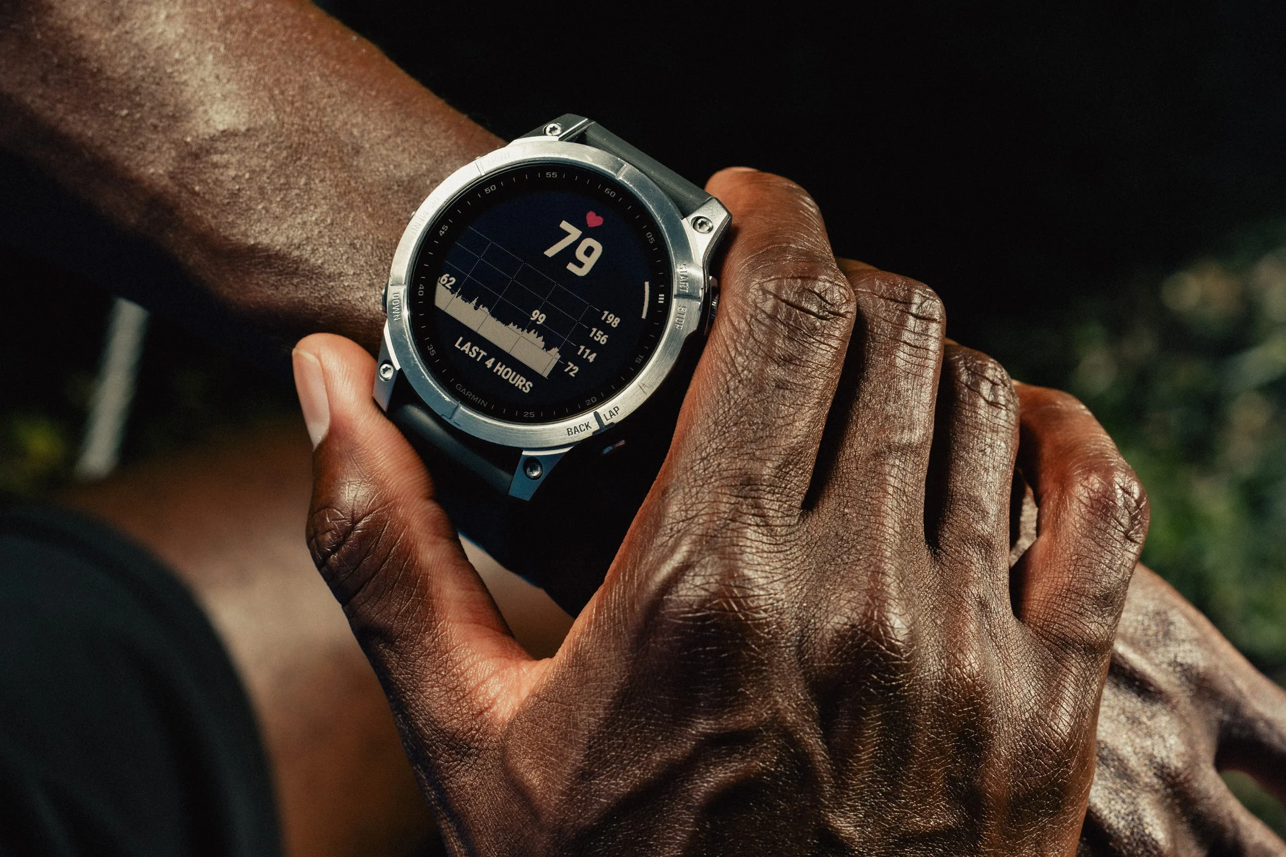 Person checking heart rate on smart watch during workout.