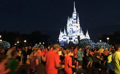 Runners run past Disney castle Runners run past Disney castle