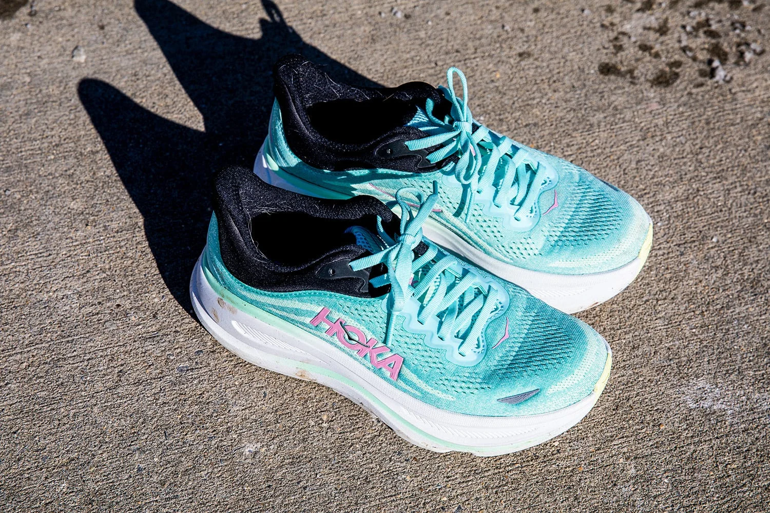 Hoka Bondi 9 sport shoes designed for running with a light blue and black color scheme