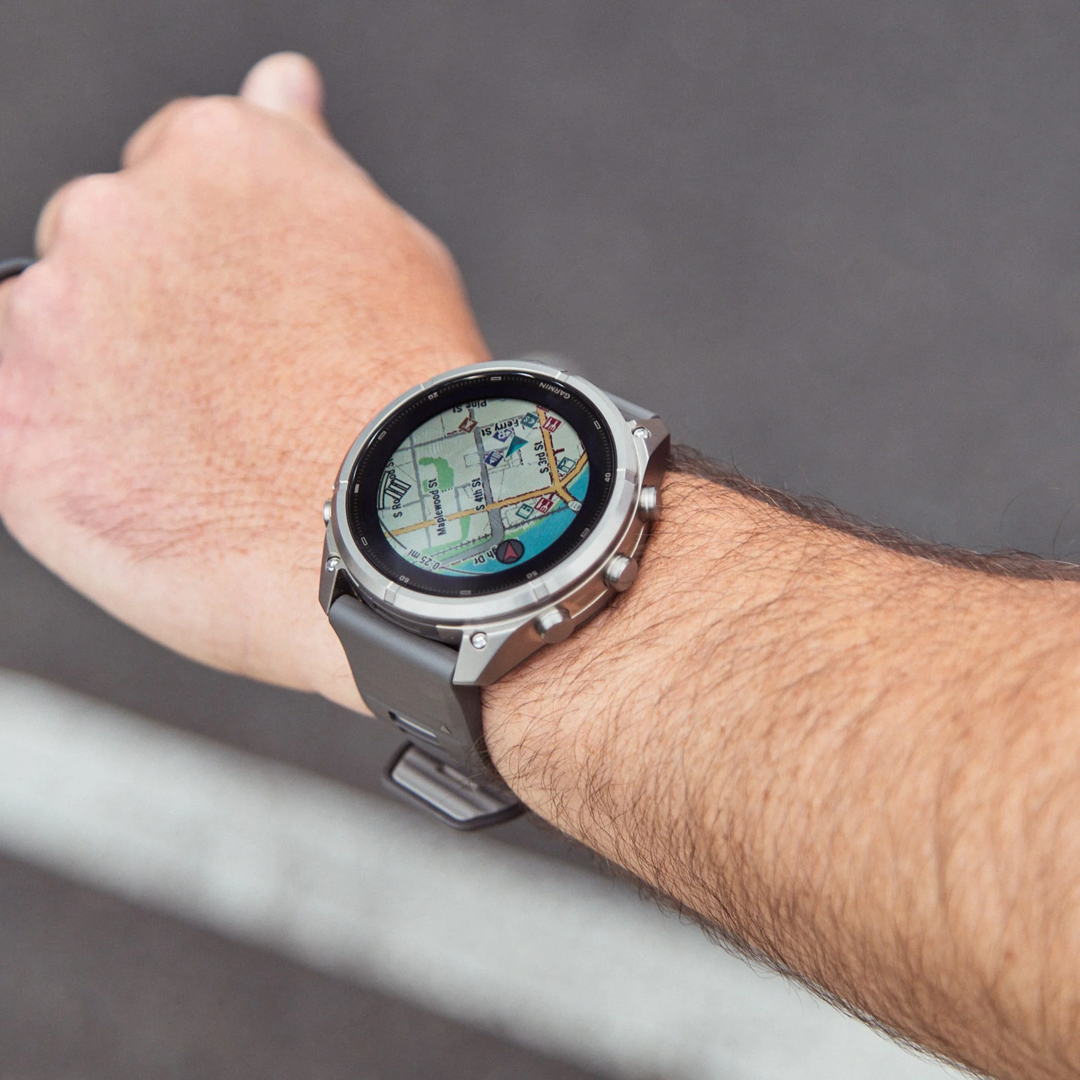 Smartwatch displaying a map on a person's wrist, showcasing navigation features and outdoor activity tools.