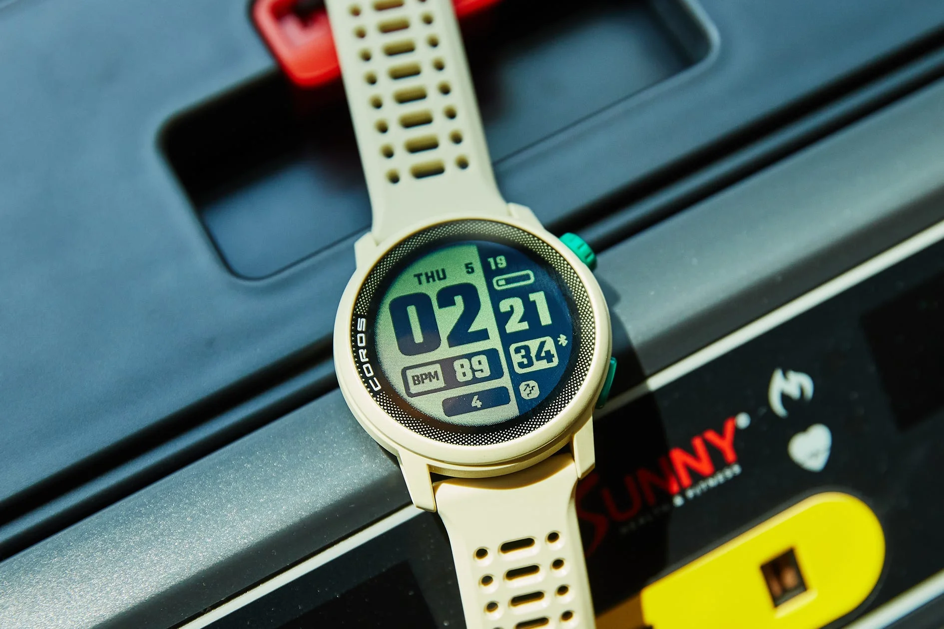 fitness watch displaying various health metrics on a treadmill console