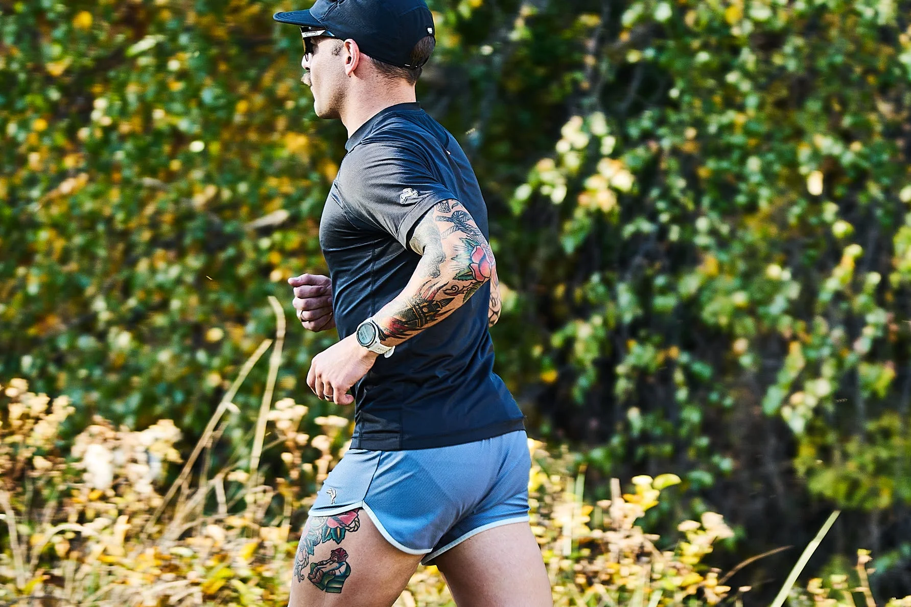 person jogging on a trail surrounded by greenery