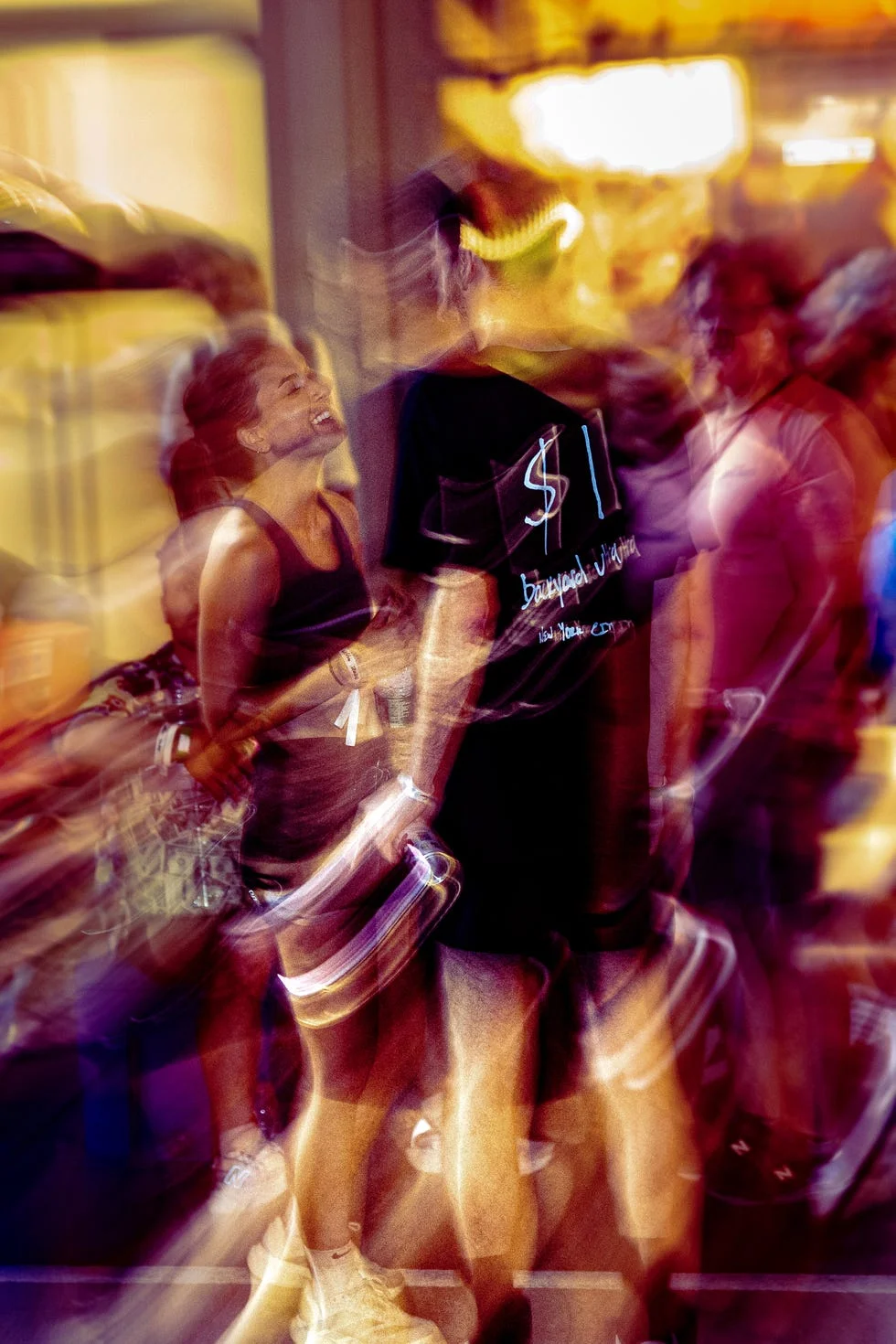Blurred motion of people laughing and talking at night event.