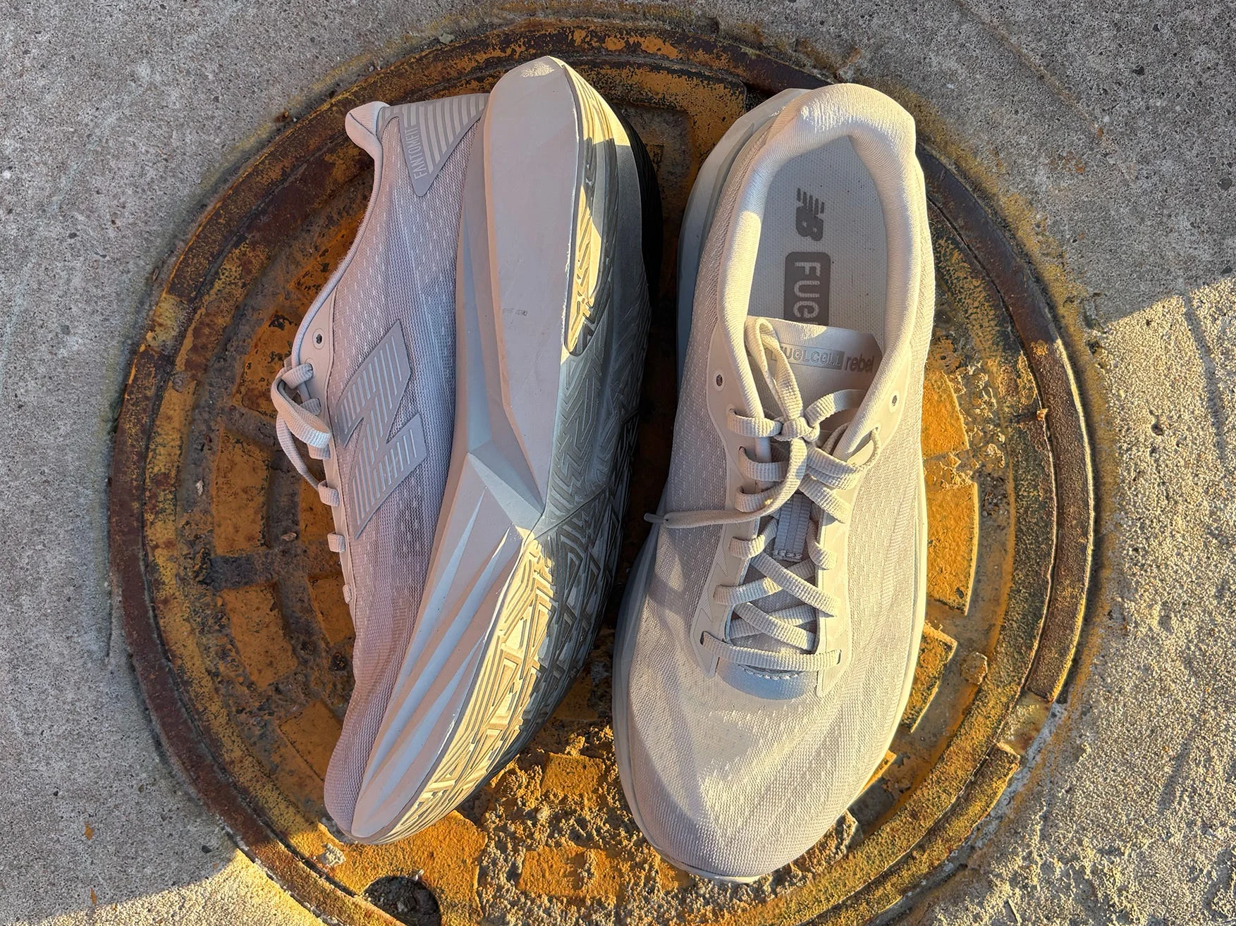 Pair New Balance FuelCell Rebel V5 on a manhole cover
