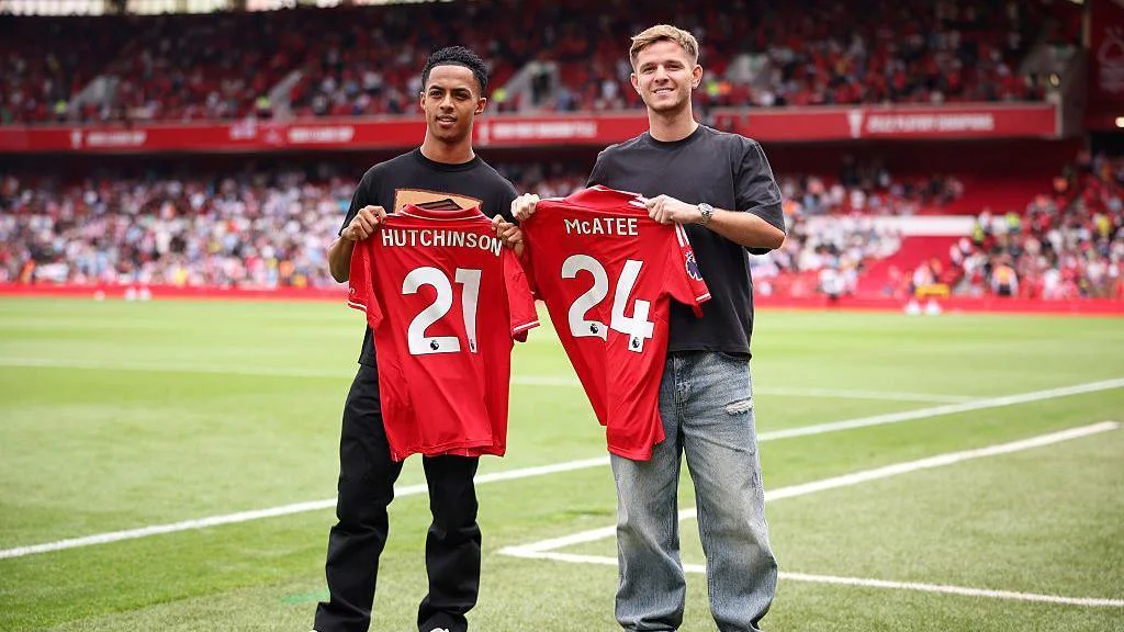 James McAtee and Omari Hutchinson holding their new shirts on the pitch