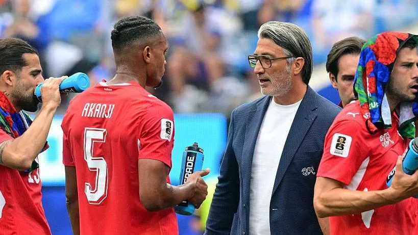 Switzerland manager Murat Yakin talks to Manuel Akanji during a cooling break against Bosnia and Herzegovina. The stoppage provided an opportunity for tactical adjustments before Switzerland’s substitutes helped transform the match